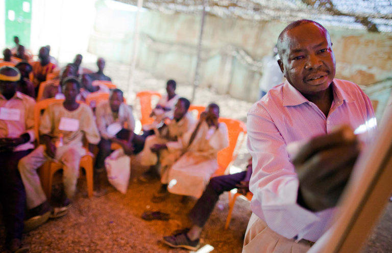 Man leads workshop on Human Rights for children. Photo credit to Albert González Farran of UNAMID via Flikr Creative Commons.