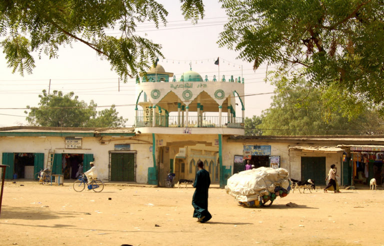 A man walks along a street in northern Nigeria.