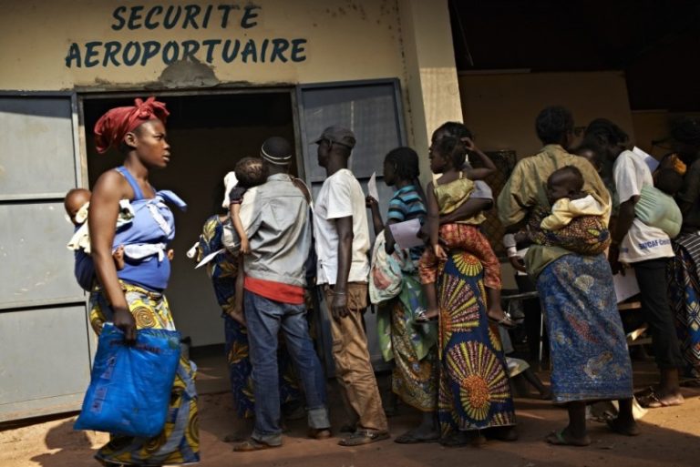 People line up at the Médecins Sans Frontières (MSF) clinic at the airport. The clinic treats hundreds of patients every day for problems such as malaria, respiratory infections, gunshot and burn wounds as well as helping mothers in labour. UNHCR / S. Phelps / December 2013