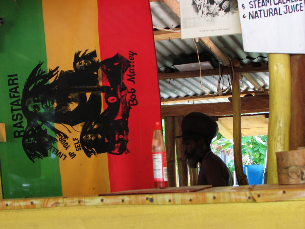 Rastafari Flag with a man standing in the background at a restaurant